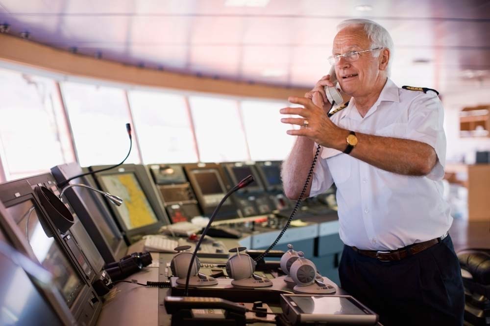 A man on a boat talking in a phone